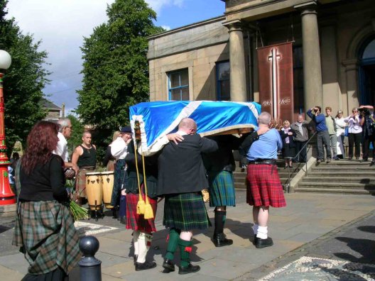 The coffin is carried into the Smith